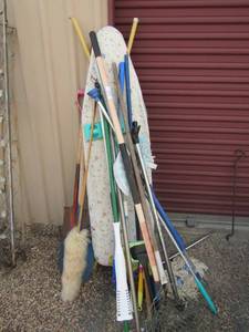 lot 35 image: Large lot of mops, brooms, rakes, ironing board and more