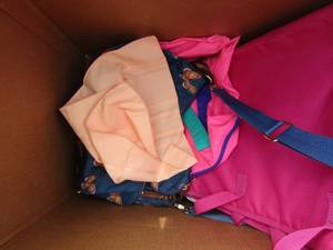 lot 28 image: box full of tote bags, over night luggage bags some new and some used