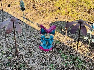 lot 121 image: Seven Piece Set of Metal Yard Art - Including Aztec Version of a Yard Gnome, Wind Spinning Flowers, Bluebonnets, &amp Plants