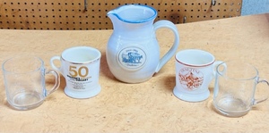lot 238 image: White With Blue Trim Vintage Ovaltine Pitcher W Four Assorted Anniversary Mugs