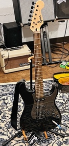 lot 3 image: Black Fender Squier Stratocaster Electric Guitar WStand