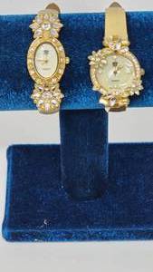 lot 107 image: Elizabeth Taylor White Diamonds Rhinestone Gold tone Watches one of the band needs attention