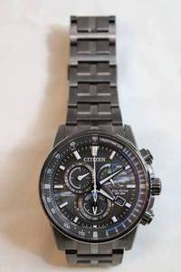 lot 62 image: Citizen Eco Drive Perpetual Chromo Watch. Model E650-5111145 Sapphire Crystal. Two tone graphite and silver flex metal band.