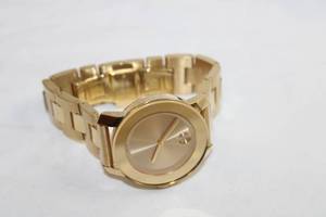 lot 66 image: Movado BOLD Watch. Model MB 01.3.34.6038 Swiss made. Two tone polished and matte gold flex band and polished gold face.