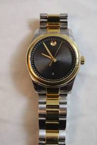 lot 68 image: Movado SPORTIVO watch. Model 27.1.20.1134 Swiss made Sapphire Crystal. Two tone black and silver flex band w black machined guilloche face