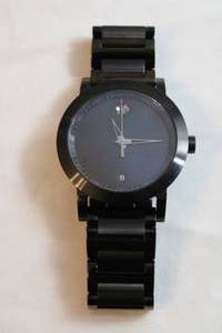 lot 70 image: Movado watch. Model  07.1.36.1202 Swiss made. Sapphire crystal. Swiss made. Black two tone polished and matte flex band.