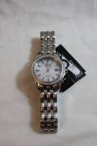 lot 73 image: Citizen Eco Drive watch w white crystal accents. Date indicator Gold plated. Model EO11-5094461 Orig retail tag $250