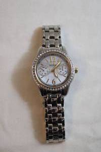 lot 74 image: Citizen Eco Drive watch w white crystal accents. Silver flex band. Model 8635-S078407