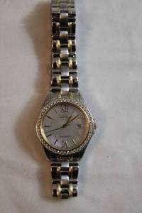 lot 75 image: Citizen Eco Drive watch w white crystal accents. Two tone gold and silver flex band. Model E011-S078567