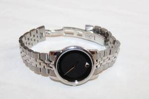 lot 85 image: Movado watch w polished and matte link flex band. Swiss made. Model 07.3.14.1123