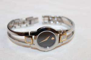lot 89 image: Movado diamond watch w gold accents. Swiss made. Diamonds tested. Model 81 E4 1842 Fold over clasp. 18 points of diamonds