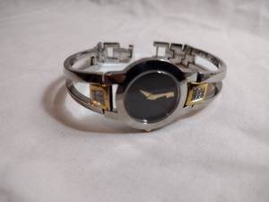 lot 90 image: Movado diamond watch w gold accents. Swiss made. Diamonds tested. Model 81 E4 1842 Fold over clasp. 18 points of diamonds