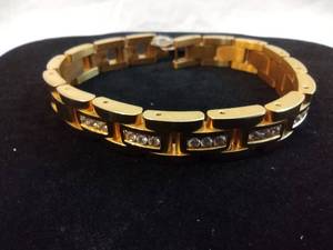 lot 106 image: Stainless Steel gold tone polished and matte finish link bracelet w crystal accents. Fold over clasp. 8.75L