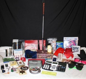 lot 246 image: Misc. Lot Saddam Husayn Playing cards, Calculators, Trinket Box, earplugs, Shoehorn and more