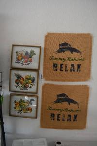 lot 202 image: Artwork Tommy Bahama Burlap canvases, (3) Fruit Prints signed RF Harnett, and No Fear Banner