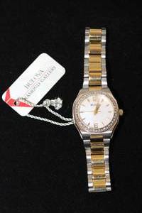 lot 37 image: Bulova diamond watch with two tone polished and matte finish flex band and diamond surround. Diamonds tested. 46 diamonds. Original tag. Model C8691218 Sapphire glass crystal.