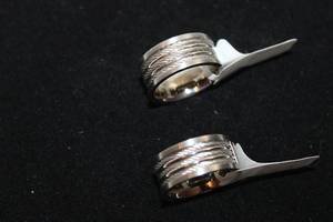 lot 41 image: (2) One Moment In Time stainless steel rings with twisted steel inserts. Marked. Size s 8 and 8.5