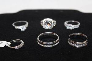 lot 43 image: (4) Sterling Silver and white stone rings. All 4 Marked 925. Missing 1 stone on two rings. Sizes 5, 7, 7.5 and 10. Also comes with 2 band rings. Unmarked. 1 missing 2 stones. Sizes 9 and 12