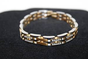 lot 394 image: Two tone gold and silver diamond bracelet. Diamonds tested. 8.75L Needs clasp or closure. 100 diamonds. Unmarked but probably Citizen.