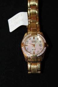 lot 405 image: Citizen Eco Drive watch with diamond surround and polished gold link flex band. 20 diamonds on surround. Diamonds tested. Model E013-5076404