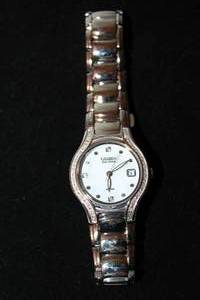 lot 407 image: Citizen Eco Drive watch with diamond surround and polished silver flex band. 20 diamonds on surround. 3 diamond interior hour markers. Diamonds tested. Model E013-5074738