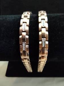 lot 105 image: (2) Two tone polished and matte finish links w crystal accents. Fold over clasp. Marked HH. Both 8L