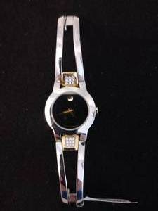 lot 396 image: Movado diamond non-working watch. Silver w gold accents. Diamonds tested. 18 diamonds. Model 81 E4 1842