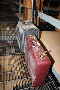 lot 555 image: 2 Briefcases Reddish Brown Case looks New, Larger Rolling Case has unknown Combination