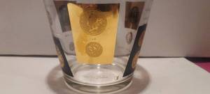 lot 12 image: MCM glass ice bucket with international coins.