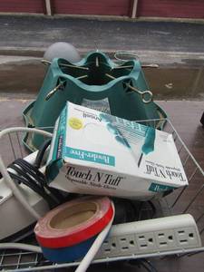 lot 68 image: Large green Christmas tree stand, new pack of disposable gloves size LG, iron and extension cord