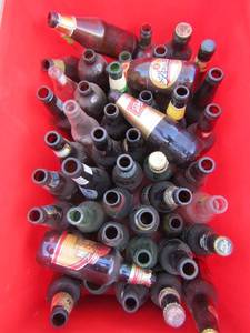 lot 115 image: Red tote full of vintage beer bottles includes, jack Daniels 1866, golden lager, Mississippi mud, Samuel Adams and many more