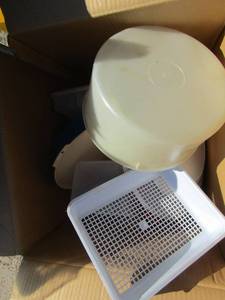 lot 148 image: Box full of plastic ware, cake covers, strainers, and more