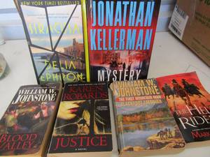 lot 190 image: Small box of paper back books including, William Johnston, The hell riders, Karen Robards and many more
