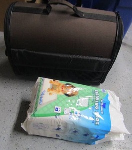 lot 72 image: Brown Pet carrier with handle on wheels like new, used pack of Advance puppy potty pads