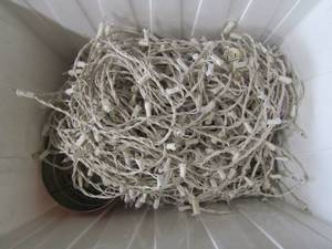lot 83 image: White tote of icicle lights for house dcor, comes with can of hooks clasps to hold