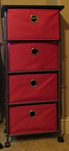 lot 53 image: 4 Drawer collapsible rolling cart, pink in color very nice and sturdy