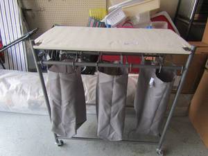 lot 114 image: 3 tier rolling laundry cart, has 3 divided areas to separate clothes