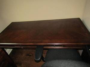 lot 125 image: 306028  solid wood cherry office desk has a pullout slot for key board, no storage just standard desk, comes with rolling office chair in great condition