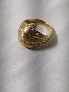 lot 34 image: Jewelry 14K yellow gold laser cut dome ring. Marked 14K. Size 7.5