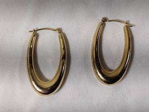 lot 37 image: Jewelry 14K yellow gold elongated hoop earrings. Marked 14K JCM. 1L