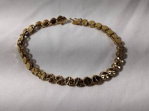 lot 41 image: Jewelry 14K yellow gold laser cut bracelet. Marked 14K 7.5L w hidden box catch and safety clasp