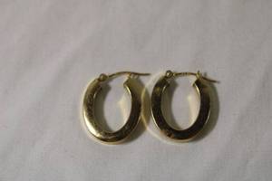 lot 43 image: Jewelry 14K yellow gold elongated hoop poststud earrings. Marked 14K JCM. Approx .75L