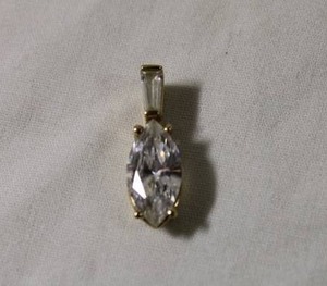 lot 45 image: Jewelry 14K yellow gold and CZ pendant. Marked 14K CZ. Approx .75L