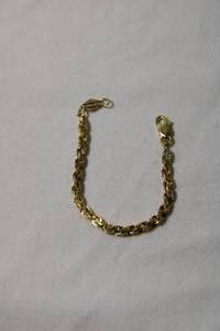lot 69 image: Jewelry 14K yellow gold rope chain infant bracelet. Marked 14K Der Israel 4L