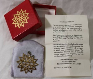 lot 97 image: Jewelry Sterling Silver vermeil (gold over sterling) star ornament in box w pamphlet. Marked  MMA 1993 Ster. From Metropolitan Museum of Art.