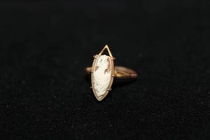 lot 196 image: Jewelry 10K yellow gold vintage ring mount with marquis shaped table. Marked 10K. Size 4.25. Original cameo is chipped and ring shank is slightly bent.