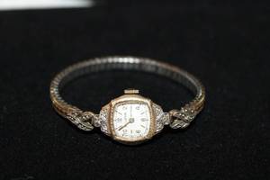lot 302 image: 10K Gold Filled Bulova diamond watch. Diamonds tested, Approx .80 carats. Marked 10K Gold Filled Bulova 8830074