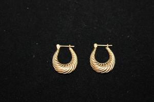 lot 308 image: 14K yellow gold textured hoop earrings. Marked 14K 34L
