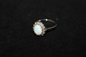 lot 315 image: 14K white gold Opal and Diamond halo ring. Marked 14K. Diamonds tested. Size 6.5