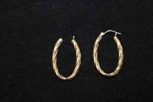 lot 341 image: 14K yellow gold elongated hoop earrings. Marked 14K JCM. 1.25L (One earring needs an ear wire)